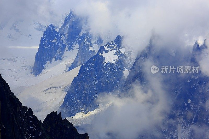 在日出时，Les Drus和Grandes jorasses在云层之上